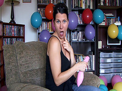 Hot woman blows air in balloon to grow bigger
