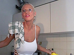Tattooed granny with glasses sucking a stranger's cock