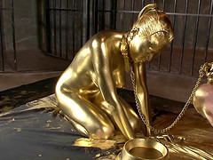 Hot slave girl painted in gold loves playing with a throbbing dick