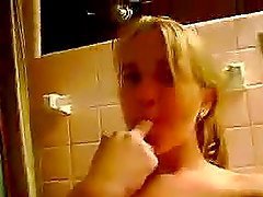 Blonde sitting on toilet masturbates