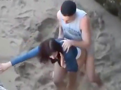 Hot young couple get caught fucking at the beach
