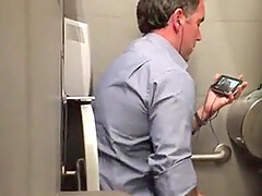 Stranger man in a public toilet filmed on a hidden camera